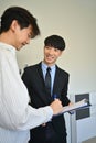 Happy young asian man signing contract with realtor. First property purchase, ownership and real estate concept Royalty Free Stock Photo