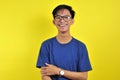 Happy Young Asian man smiling wearing glasses, isolated on yellow Royalty Free Stock Photo