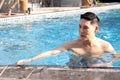 Happy young Asian man swimming in blue water pool, relaxing swimmer male have fun activity in summer. Swimming for exercise, swim Royalty Free Stock Photo