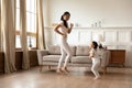Happy young Asian mom and daughter dancing at home Royalty Free Stock Photo