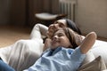 Happy young asian mother relaxing on couch with small kid. Royalty Free Stock Photo