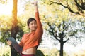 Happy young asian woman be smile working with her laptop and hand up on a bench in the park outdoors on vacation time Royalty Free Stock Photo