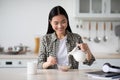 Happy young asian woman eating healthy oatmeal Royalty Free Stock Photo