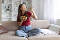 Happy young asian woman enjoying fresh salad bowl at home Royalty Free Stock Photo