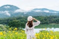 Happy young Asian woman enjoying in yellow flower field at sunset Royalty Free Stock Photo