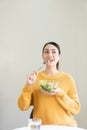 Happy young Asian woman with fresh vegetables and fresh fruits, healthy concept working lunch at home, Royalty Free Stock Photo