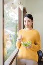 Happy young Asian woman with fresh vegetables and fresh fruits, healthy concept working lunch at home, Royalty Free Stock Photo