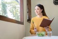 Happy young Asian woman with fresh vegetables and fresh fruits, healthy concept working lunch at home, Royalty Free Stock Photo