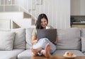 Happy young asian woman having conversation chatting while using laptop at house. Work at home, Video conference, Online Royalty Free Stock Photo