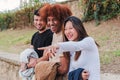 Happy young asian woman having fun and showing something funny to her friends and pointing with her finger outdoors Royalty Free Stock Photo