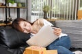 Happy young asian woman holding credit card and laptop sitting on sofa at home Royalty Free Stock Photo