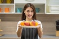 Happy young Asian woman holding fresh apple fruit in the modern kitchen Royalty Free Stock Photo