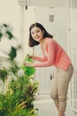 Happy Young Asian Woman housewife Watering flowers On Balcony Royalty Free Stock Photo