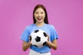 Happy Young Asian woman looking at camera, holding a soccer ball, FIFA World Cup concept Royalty Free Stock Photo