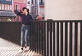 Happy young asian woman listening to music and having fun with headphones on the street. Royalty Free Stock Photo