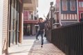 Happy young asian woman listening to music and having fun with headphones on the street. Royalty Free Stock Photo