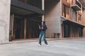 Happy young asian woman listening to music and having fun with headphones via smartphone on the street. Royalty Free Stock Photo