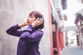 Happy young asian woman listening to music with headphones on the street. Royalty Free Stock Photo