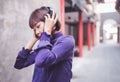 Happy young asian woman listening to music with headphones on the street. Royalty Free Stock Photo