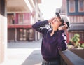 Happy young asian woman listening to music with headphones on the street. Royalty Free Stock Photo