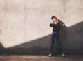 Happy young asian woman listening to music with headphones on the street. Royalty Free Stock Photo