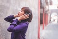 Happy young asian woman listening to music with headphones on the street. Royalty Free Stock Photo