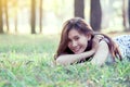 Happy young asian woman lying down on grass in the park Royalty Free Stock Photo