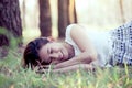 Happy young asian woman lying down on grass Royalty Free Stock Photo