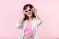 happy young asian woman model with stylish trendy sun glasses enjoy listening music by headphone audio and dancing isolated on