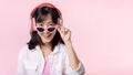 happy young asian woman model with stylish trendy sun glasses enjoy listening music by headphone audio and dancing isolated on