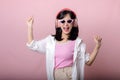 happy young asian woman model with stylish trendy sun glasses enjoy listening music by headphone audio and dancing isolated on