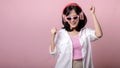 happy young asian woman model with stylish trendy sun glasses enjoy listening music by headphone audio and dancing isolated on