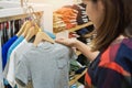 Happy young asian woman shopping trendy kid clothes for her`s son in shopping mall, Selective focus Royalty Free Stock Photo