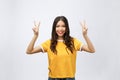 Happy young asian woman showing two fingers or victory gesture with blank copyspace area for text,Portrait of beautiful Royalty Free Stock Photo