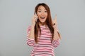 Happy young asian woman talking by phone have an idea. Royalty Free Stock Photo
