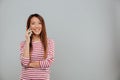 Happy young asian woman talking by phone Royalty Free Stock Photo