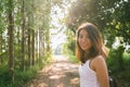 Happy young Asian woman traveler with backpack walking in forest. Hiker Asian woman with backpack walking on path in summer forest Royalty Free Stock Photo