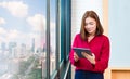 Happy young Asian woman using her computer tablet in her office Royalty Free Stock Photo