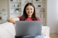 Happy Young Asian Woman Using Laptop Computer At Home Royalty Free Stock Photo