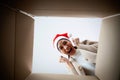 Happy young asian woman wearing christmas hat and unpacking gift box Royalty Free Stock Photo