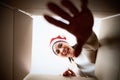 Happy young asian woman wearing christmas hat and unpacking gift box Royalty Free Stock Photo