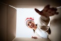 Happy young asian woman wearing christmas hat and unpacking gift box Royalty Free Stock Photo