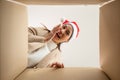 Happy young asian woman wearing christmas hat and unpacking gift box Royalty Free Stock Photo