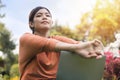 Happy young asian woman working with her laptop and relax on a grass in the park outdoors on vacation time Royalty Free Stock Photo