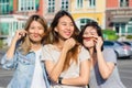 Happy young Asian women group city lifestyle playing and chatting each other among the pastel building city on weekend. Royalty Free Stock Photo