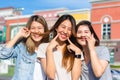 Happy young Asian women group city lifestyle playing and chatting each other among the pastel building city on weekend. Royalty Free Stock Photo