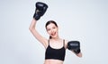 Happy young athletic girl in boxing gloves raised her hands up Royalty Free Stock Photo