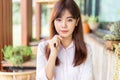 Happy young attractive asian business woman smiling at camera, standing at outdoor patio of her office Royalty Free Stock Photo