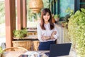 Happy young attractive asian business woman smiling at camera, standing at outdoor patio of her office Royalty Free Stock Photo