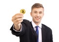 Happy young attractive businessman trader holding bitcoin cryptocurrency, with blurred face, isolated on white Royalty Free Stock Photo